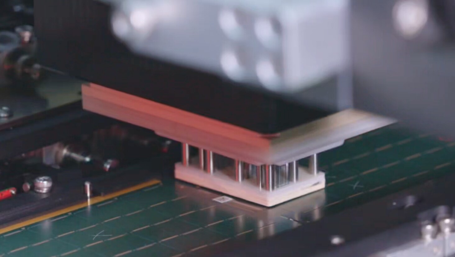 Close view of the IC substrate fixture head making contact with the substrate