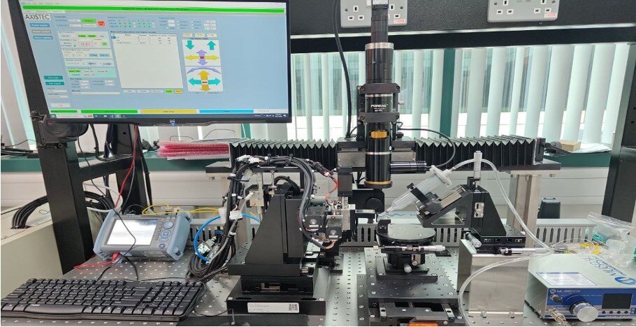 Axis-Tec photonic integrated circuit test station with motion control, microscope and optical instrumentation